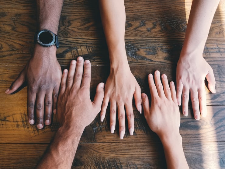 Hands on a table. Photo courtesy of Unsplash, credit to Clay Banks.