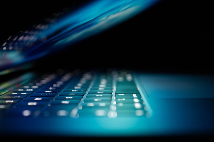 a photo of a MacBook keyboard with illuminated letters. photo courtesy of Phillip Katzenberger and Unsplash.