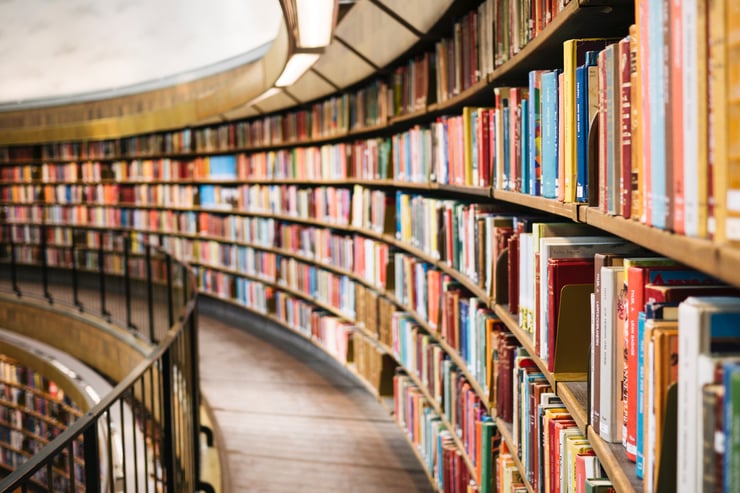 Colorful books on a bookshelf in a library. Photo by Susan Q Yin on Unsplash